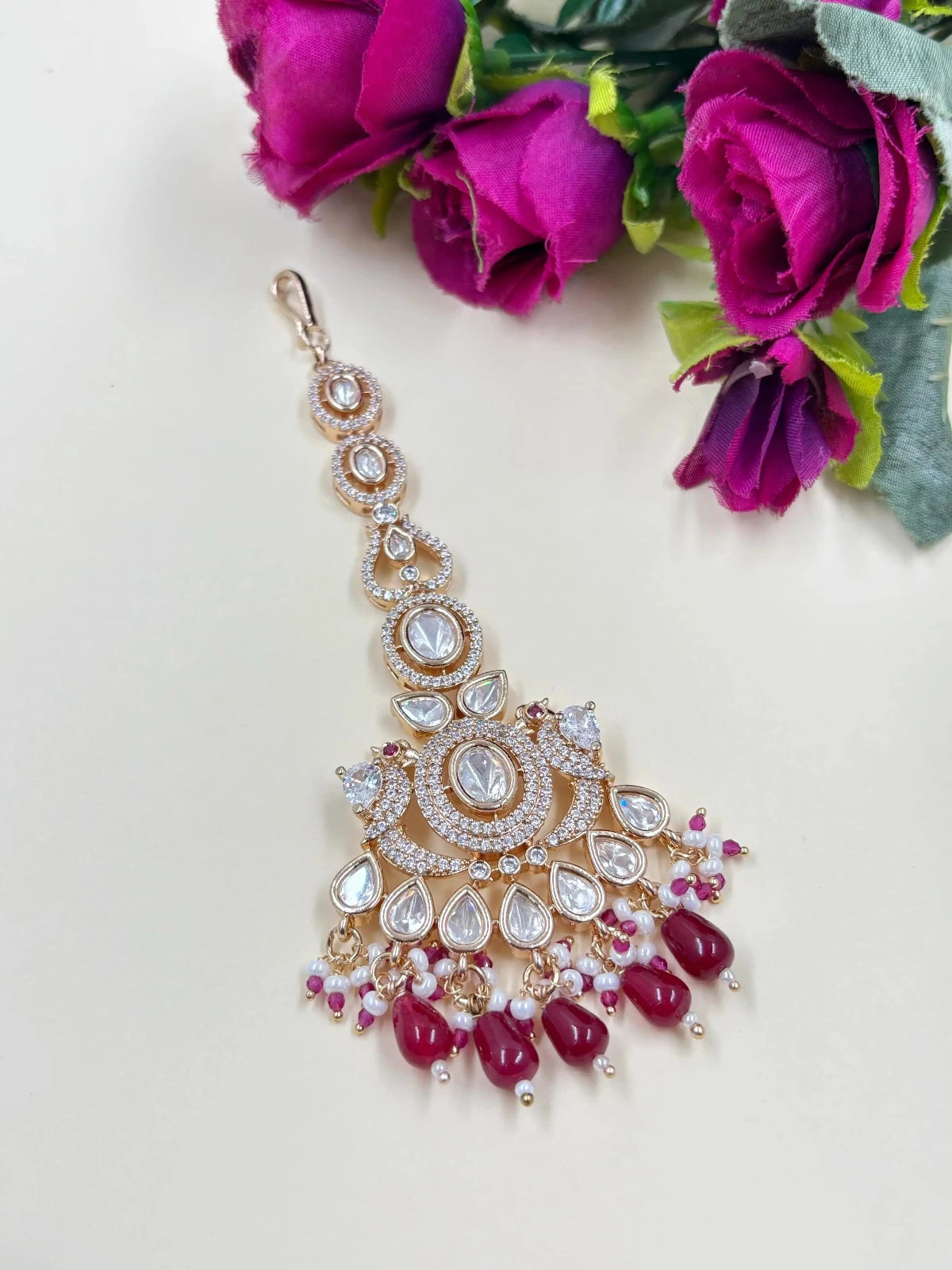 Designer Rose Gold Finish AD And Polki Big Size Maang Tikka with red color beads.